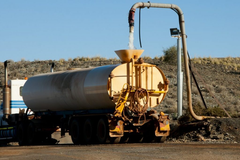 Industrial water truck being filled to capacity