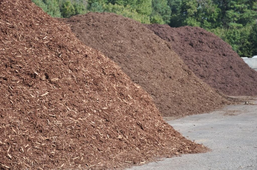 Large piles of landscaping supplies sitting at a landscaping shop